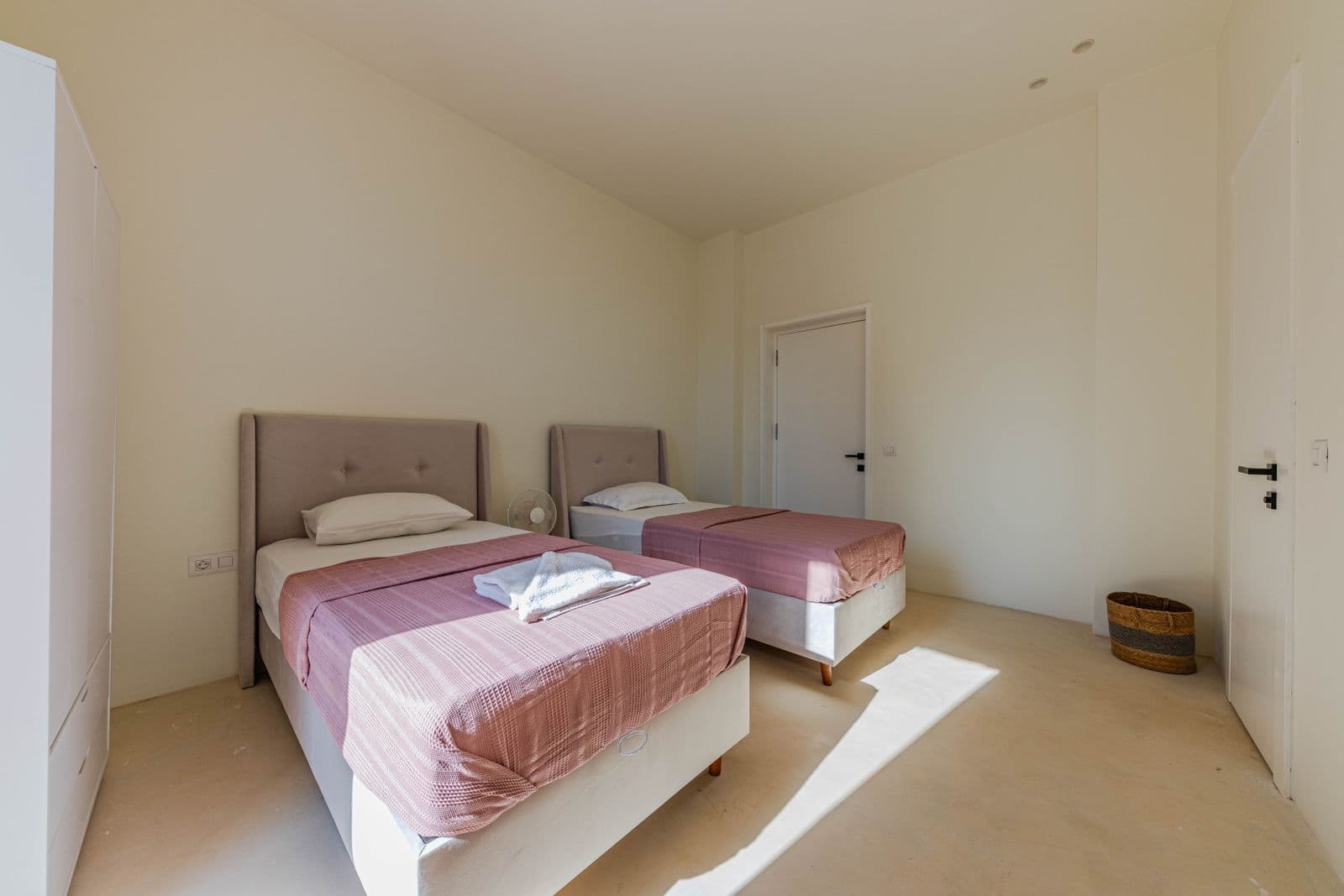 Illustrative example of a twin-bed room in a similar simple style — not an actual KwaNomzi photo