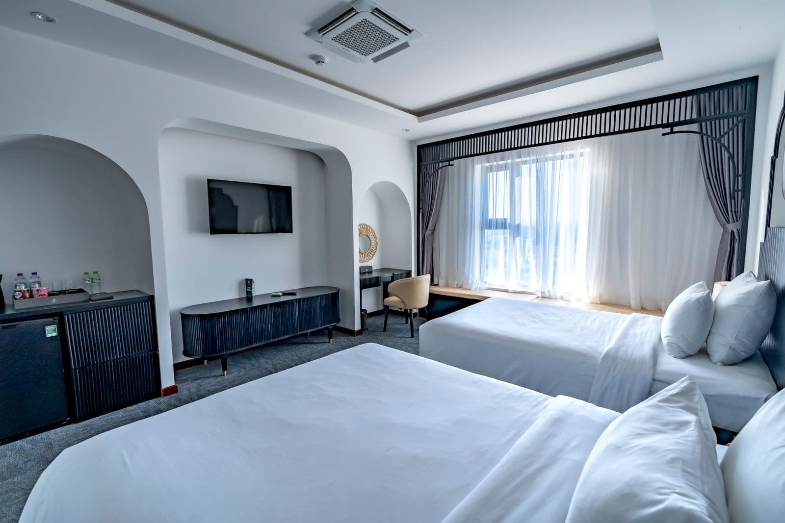 Illustrative example of a two-double-bed room in a similar simple style — not an actual KwaNomzi photo